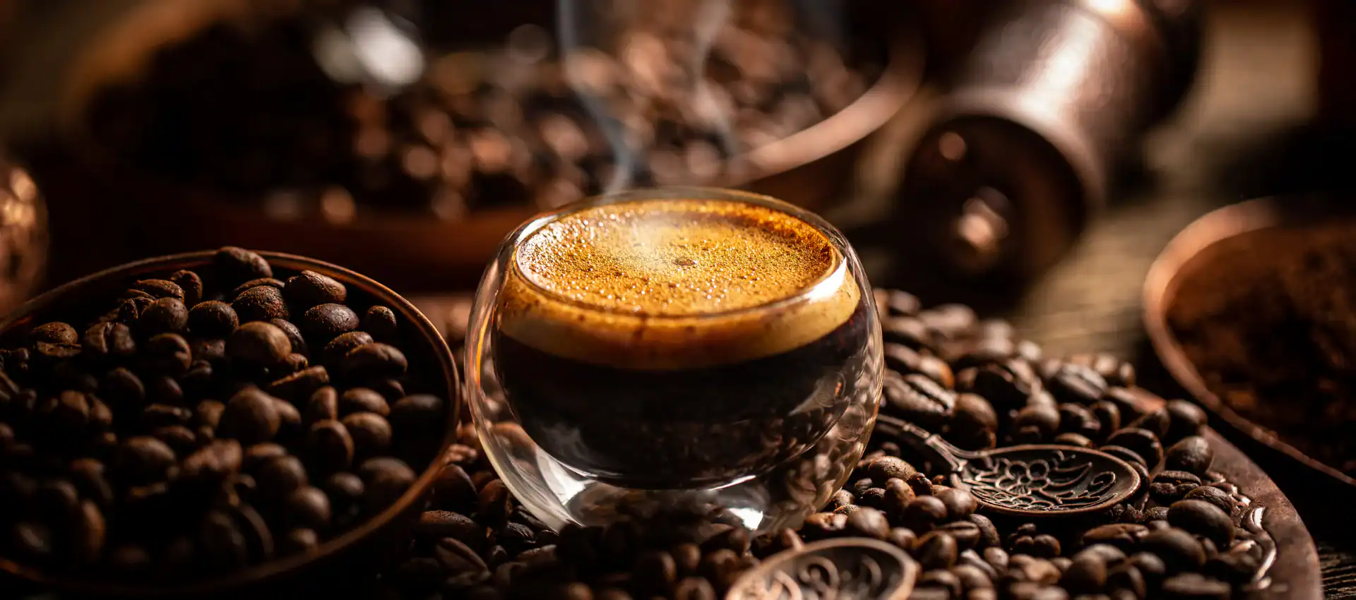 A steaming cup of espresso sits on a bed of roasted coffee beans, surrounded by bowls filled with more beans and coffee grounds&mdash;capturing the inviting ambiance of a cozy cafe NYC scene in warm, ambient lighting.