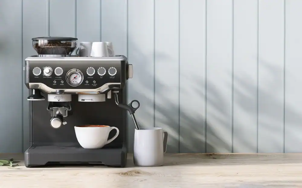 A modern espresso machine with cups on top sits on a wooden counter against a light blue paneled wall. A white coffee cup and a gray mug are placed in front of the machine.